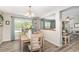 Bright dining area with natural light, showcasing wood floors, modern lighting, and stylish furnishings at 3321 Pintello Ave, New Smyrna Beach, FL 32168