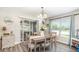 Cozy dining area featuring a stylish light fixture, wood floors and a sliding glass door at 3321 Pintello Ave, New Smyrna Beach, FL 32168