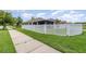 Exterior view of home with a manicured lawn and white vinyl privacy fence and a sidewalk at 3321 Pintello Ave, New Smyrna Beach, FL 32168