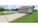 Exterior view of house with a white fence, a driveway, and an attached garage at 3321 Pintello Ave, New Smyrna Beach, FL 32168
