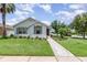 Charming single-story home featuring a beautifully landscaped front yard and a welcoming walkway at 3321 Pintello Ave, New Smyrna Beach, FL 32168
