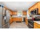 Traditional kitchen with stainless steel appliances, light oak cabinets, and modern countertops at 3321 Pintello Ave, New Smyrna Beach, FL 32168