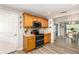 Well-lit kitchen featuring wooden cabinets, modern appliances, and wood grain floors at 3321 Pintello Ave, New Smyrna Beach, FL 32168