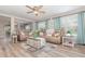 Spacious living area with wood-look flooring, comfortable seating, and plenty of natural lighting at 3321 Pintello Ave, New Smyrna Beach, FL 32168