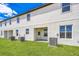 Spacious backyard featuring lush green grass and a covered patio at 781 Poppy Ln, Dundee, FL 33838