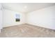 Bedroom features neutral carpet, a window offering natural light, and electrical outlets for convenience at 781 Poppy Ln, Dundee, FL 33838