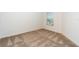 Bright bedroom featuring plush carpet, a window with blinds, and ample natural light at 781 Poppy Ln, Dundee, FL 33838