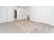 Neutral bedroom has carpet, two doors, and view into adjoining bathroom; and is move-in ready at 781 Poppy Ln, Dundee, FL 33838