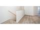 Hallway with carpeted stairs and railing leading to the upper level of the home and a bedroom at 781 Poppy Ln, Dundee, FL 33838