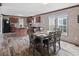 Cozy dining area featuring stone accents, gray table set, and an open view to the kitchen at 40144 Camphor Rd, Lady Lake, FL 32159