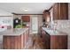 Open kitchen showcasing stone accent walls, granite countertops, and stainless steel appliances at 40144 Camphor Rd, Lady Lake, FL 32159