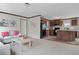 Comfortable living room and kitchen area with carpeted flooring, modern finishes, and neutral tones at 40144 Camphor Rd, Lady Lake, FL 32159