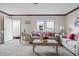 Inviting living room with neutral walls, matching sofas, and bright natural light at 40144 Camphor Rd, Lady Lake, FL 32159
