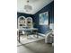Stylish home office featuring dark blue walls, modern desk, and decorative shelving at 6200 Sw 97Th St, Ocala, FL 34476