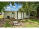 The shed has white siding with a dark border and a small window at 833 N Suwannee Ave, Lakeland, FL 33815