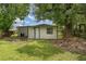 A small backyard is shown with green grass and a shed at 833 N Suwannee Ave, Lakeland, FL 33815