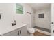 Updated bathroom featuring a tiled shower, updated vanity, and wood-look floors at 833 N Suwannee Ave, Lakeland, FL 33815