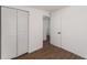 This bedroom features wood flooring and a closet with folding doors at 833 N Suwannee Ave, Lakeland, FL 33815