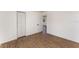 Bedroom with wood-look flooring and a closet with white louvered doors at 833 N Suwannee Ave, Lakeland, FL 33815