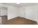 Bedroom showcasing wood-look flooring, white walls, and neutral door at 833 N Suwannee Ave, Lakeland, FL 33815