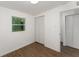 Bedroom featuring wood-look floors, neutral paint, and a closet with white doors at 833 N Suwannee Ave, Lakeland, FL 33815