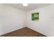 Bedroom featuring new flooring and a view of mature trees through the window at 833 N Suwannee Ave, Lakeland, FL 33815