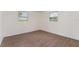 Bedroom featuring wood-look flooring, fresh white walls, and two windows at 833 N Suwannee Ave, Lakeland, FL 33815