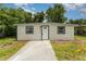 Charming single story home with a fresh exterior paint job, sidewalk, and manicured lawn at 833 N Suwannee Ave, Lakeland, FL 33815