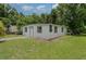 Cozy home featuring fresh paint, a well-maintained lawn, and a welcoming entrance at 833 N Suwannee Ave, Lakeland, FL 33815