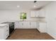 Bright kitchen featuring white cabinets, quartz countertops, and stainless steel appliances at 833 N Suwannee Ave, Lakeland, FL 33815