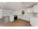 Modern kitchen with stainless steel appliances, white cabinets, and wood-look floors at 833 N Suwannee Ave, Lakeland, FL 33815