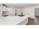 Open kitchen with a quartz countertop, white cabinets, an island, and stainless steel appliances at 833 N Suwannee Ave, Lakeland, FL 33815
