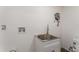 The laundry room includes a sink and faucet on a white base cabinet at 833 N Suwannee Ave, Lakeland, FL 33815