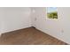 Bright room featuring wood-look floors, a white door with glass, and natural light from a window at 833 N Suwannee Ave, Lakeland, FL 33815