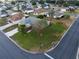 Aerial view of a well-maintained home with a manicured lawn in a peaceful neighborhood with mature trees at 1074 Canary S Cir, Lakeland, FL 33809