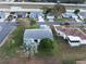 Aerial view of home with well-kept lawn and landscaping near neighborhood streets and highway at 1074 Canary S Cir, Lakeland, FL 33809