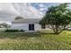 Well kept backyard featuring a concrete patio accessible through sliding glass doors and a mature tree offering shade at 1074 Canary S Cir, Lakeland, FL 33809