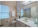 Bathroom features a white vanity, a large mirror, and a shower-tub combination at 1074 Canary S Cir, Lakeland, FL 33809