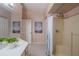Bathroom featuring a tiled shower, a white vanity, and soft neutral tones at 1074 Canary S Cir, Lakeland, FL 33809