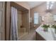Bathroom featuring a shower with a seat, a neutral color scheme, and a white vanity at 1074 Canary S Cir, Lakeland, FL 33809