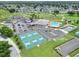 Aerial view of community center with pool, tennis courts, and parking at 1074 Canary S Cir, Lakeland, FL 33809