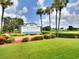 Entrance to Sandpiper Golf & Country Club featuring lush landscaping and well-manicured green at 1074 Canary S Cir, Lakeland, FL 33809