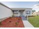 Charming home featuring a wheelchair ramp, a well-manicured lawn, and mature landscaping at 1074 Canary S Cir, Lakeland, FL 33809