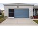 Garage featuring a functional screen and a concrete driveway at 1074 Canary S Cir, Lakeland, FL 33809