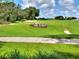 Scenic view of 'The Links' golf course with lush green fairway and mature trees at 1074 Canary S Cir, Lakeland, FL 33809