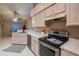 Spacious kitchen features stainless steel appliances and seamless access to dining area at 1074 Canary S Cir, Lakeland, FL 33809
