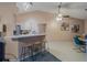 Open kitchen view features a breakfast bar with seating, stylish lighting, and seamless access to dining area at 1074 Canary S Cir, Lakeland, FL 33809