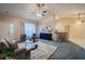 Inviting living room boasting plush carpet, a ceiling fan, modern decor, and ample natural light at 1074 Canary S Cir, Lakeland, FL 33809