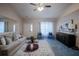 Comfortable living room featuring plush carpet, neutral walls, modern furnishings, and a ceiling fan at 1074 Canary S Cir, Lakeland, FL 33809