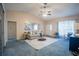 Bright living room with vaulted ceiling, ceiling fan, neutral décor, and plush carpet creating a welcoming space at 1074 Canary S Cir, Lakeland, FL 33809